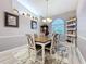 Elegant dining room featuring a wooden table with upholstered chairs, a decorative rug, and shelving at 1634 Lady Bowers Trl, Lakeland, FL 33809