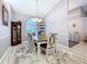 Cozy dining room with light wood flooring, a wooden dining set, and a glimpse into the front foyer at 1634 Lady Bowers Trl, Lakeland, FL 33809