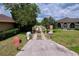 Long gated driveway leading up to a lakefront house with well-maintained landscaping at 1634 Lady Bowers Trl, Lakeland, FL 33809