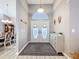 Inviting entryway with decorative double doors, chandelier, and stylish accents, adjacent to the dining room at 1634 Lady Bowers Trl, Lakeland, FL 33809