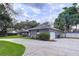 Attractive gray home features a well-kept lawn and convenient attached garage at 1634 Lady Bowers Trl, Lakeland, FL 33809