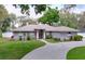 Charming single-story home with well-manicured lawn, tasteful landscaping, and a circular driveway at 1634 Lady Bowers Trl, Lakeland, FL 33809