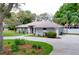 Well-maintained single-story home with a circular driveway, mature trees, and lush landscaping at 1634 Lady Bowers Trl, Lakeland, FL 33809