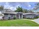 Beautiful single-story home with a well-kept lawn, mature landscaping, and welcoming entryway at 1634 Lady Bowers Trl, Lakeland, FL 33809