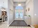 Spacious foyer with double doors, a transom window, and light wood flooring, leading to a dining area at 1634 Lady Bowers Trl, Lakeland, FL 33809
