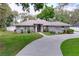 Charming one-story home with a manicured lawn and a long driveway at 1634 Lady Bowers Trl, Lakeland, FL 33809