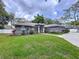 Charming single-story home featuring a lush green lawn and well-maintained landscaping, creating a welcoming curb appeal at 1634 Lady Bowers Trl, Lakeland, FL 33809