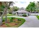 Charming gray home features a well-kept lawn, mature trees, and an attached garage at 1634 Lady Bowers Trl, Lakeland, FL 33809