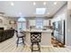 Bright kitchen with white cabinetry, stainless steel appliances, skylight, and an island with barstool seating at 1634 Lady Bowers Trl, Lakeland, FL 33809