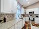 Bright kitchen features white cabinets, granite countertops, and stainless appliances at 1634 Lady Bowers Trl, Lakeland, FL 33809