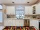 Stylish kitchen with white cabinetry, mosaic backsplash, and modern appliances at 1634 Lady Bowers Trl, Lakeland, FL 33809