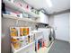 Well-stocked laundry room with washer, dryer, utility sink, and ample storage shelving at 1634 Lady Bowers Trl, Lakeland, FL 33809
