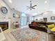 Cozy living room featuring fireplace, modern decor, and access to kitchen at 1634 Lady Bowers Trl, Lakeland, FL 33809