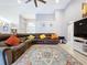 Spacious living room with a large sectional sofa and a patterned area rug at 1634 Lady Bowers Trl, Lakeland, FL 33809