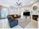 Open-concept living room features a fireplace and a large sectional sofa at 1634 Lady Bowers Trl, Lakeland, FL 33809