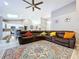 Bright living room with a skylight, sectional sofa, and view into the kitchen at 1634 Lady Bowers Trl, Lakeland, FL 33809