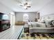 Bright main bedroom with a fireplace, exercise equipment, ceiling fan, and sitting area at 1634 Lady Bowers Trl, Lakeland, FL 33809