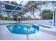 Screened-in pool and spa surrounded by a white fence and lush trees at 1634 Lady Bowers Trl, Lakeland, FL 33809