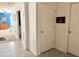 Well-lit hallway with tiled flooring, leading to rooms with inviting decor and a calming atmosphere at 2987 Neverland Dr, New Smyrna Beach, FL 32168