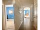Inviting hallway with tiled floor and bright blue accent wall, giving view to multiple rooms at 2987 Neverland Dr, New Smyrna Beach, FL 32168