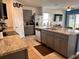 Modern kitchen with gray cabinetry, granite countertops, stainless steel appliances, and open layout at 2987 Neverland Dr, New Smyrna Beach, FL 32168