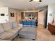 Open-concept living room features a breakfast bar, modern kitchen, and comfortable furniture at 2987 Neverland Dr, New Smyrna Beach, FL 32168