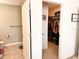View of walk-in closet from the bathroom, offering ample storage and organization with a tiled floor at 2987 Neverland Dr, New Smyrna Beach, FL 32168