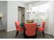 Bright dining area featuring a round table, coral-colored chairs, chandelier, and a large window at 3013 Howley Aly, St Cloud, FL 34771