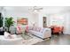 Bright open-concept living room featuring a large sectional sofa, decorative pillows, and a modern glass coffee table at 3013 Howley Aly, St Cloud, FL 34771