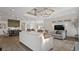 Bright living room boasts wood floors, a modern light fixture, and an open floor plan at 3013 Howley Aly, St Cloud, FL 34771