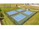 Outdoor pickleball courts feature vibrant blue surfaces and are surrounded by manicured lawns at 3013 Howley Aly, St Cloud, FL 34771