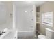 Bright bathroom features a tiled tub/shower combo, vanity, and built in shelves at 1101 Dr Martin L King Jr Way, Haines City, FL 33844