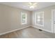 Neutral bedroom with tile floors, two windows, and a ceiling fan at 1101 Dr Martin L King Jr Way, Haines City, FL 33844