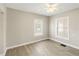 Bedroom featuring tile floors, neutral walls, and two well-lit windows at 1101 Dr Martin L King Jr Way, Haines City, FL 33844
