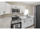 Modern kitchen features white cabinets, stainless steel appliances, and stylish countertops at 1101 Dr Martin L King Jr Way, Haines City, FL 33844