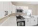 Modern kitchen featuring white cabinets, stainless steel appliances, and marble countertops at 1101 Dr Martin L King Jr Way, Haines City, FL 33844
