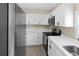 Bright kitchen showcasing stainless steel refrigerator, white cabinets and marble countertops at 1101 Dr Martin L King Jr Way, Haines City, FL 33844