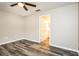 Neutrally painted bedroom with updated lighting and wood-look flooring at 2216 Heathwood Cir, Orlando, FL 32828