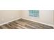 Neutral bedroom features wood-look flooring and a bright window view at 2216 Heathwood Cir, Orlando, FL 32828