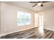 Bright bedroom features wood-look flooring, a ceiling fan and neutral paint colors at 2216 Heathwood Cir, Orlando, FL 32828