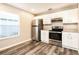 Modern kitchen featuring stainless steel appliances, granite countertops, and white cabinets at 2216 Heathwood Cir, Orlando, FL 32828