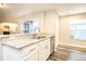 Modern kitchen features granite countertops, a stainless steel sink, and white cabinets at 2216 Heathwood Cir, Orlando, FL 32828