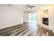 Spacious living room features hardwood floors, a fireplace, and sliding glass doors at 2216 Heathwood Cir, Orlando, FL 32828