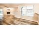 Bright living room features hardwood floors, a fireplace, and a large window at 2216 Heathwood Cir, Orlando, FL 32828
