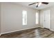 Bright bedroom featuring two windows, ceiling fan, light-colored walls, and modern laminate floors at 408 S Edgemon Ave, Winter Springs, FL 32708