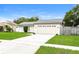 Inviting single-story home with a lush lawn, a two-car garage, and updated roof at 408 S Edgemon Ave, Winter Springs, FL 32708