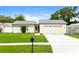 Well-maintained single-story home featuring a manicured front lawn and a two-car garage at 408 S Edgemon Ave, Winter Springs, FL 32708