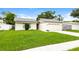 Charming single-story home with green lawn and an attached two-car garage at 408 S Edgemon Ave, Winter Springs, FL 32708