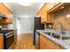 Updated kitchen boasting granite countertops, stainless steel appliances, and wood cabinets at 408 S Edgemon Ave, Winter Springs, FL 32708