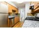 Modern kitchen features granite countertops, stainless steel appliances, and wood-look flooring at 408 S Edgemon Ave, Winter Springs, FL 32708